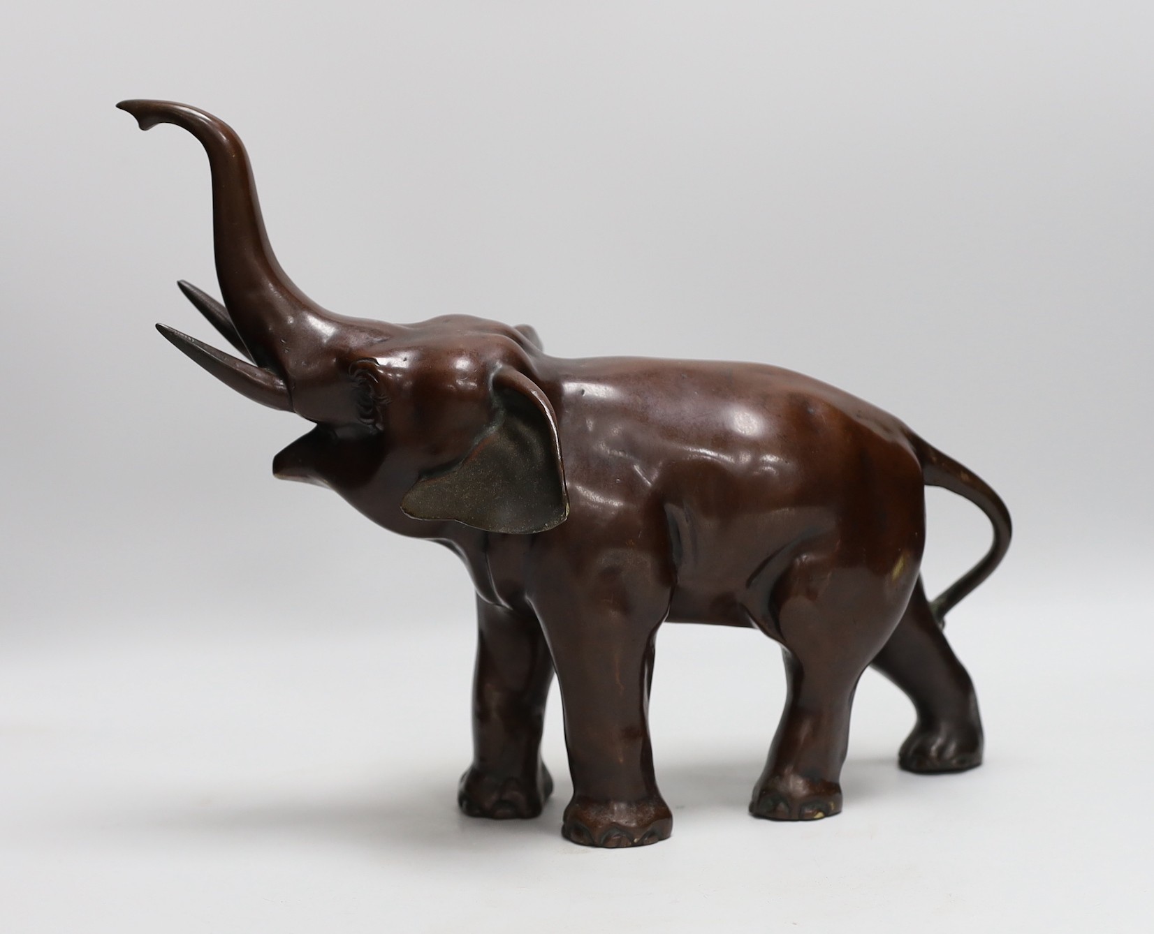 A 20th century patinated bronze model of an elephant, 29cm tall
